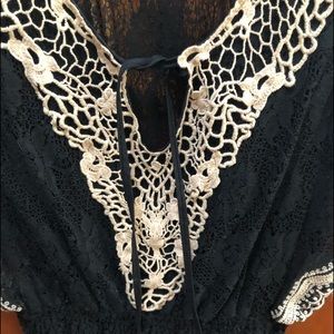Pretty lace black/white top very becoming with gathering waist.